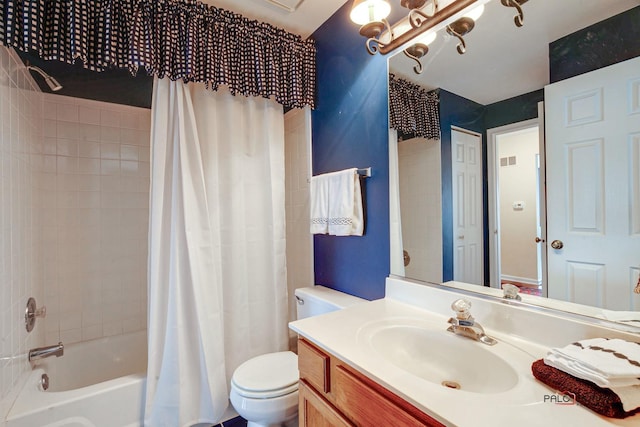 bathroom featuring visible vents, vanity, shower / bath combo with shower curtain, and toilet