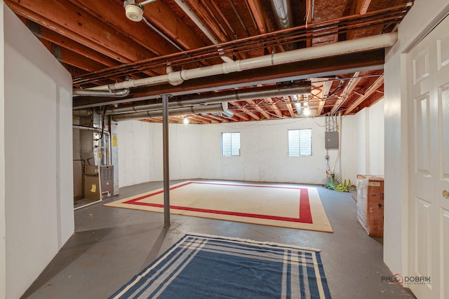 basement featuring heating unit and electric panel
