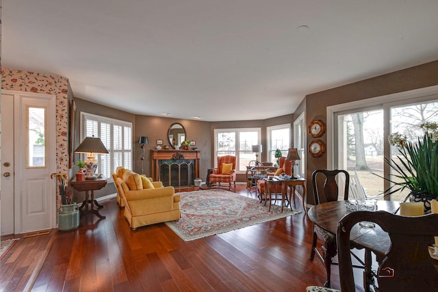 living room featuring hardwood / wood-style floors, a fireplace, and baseboards