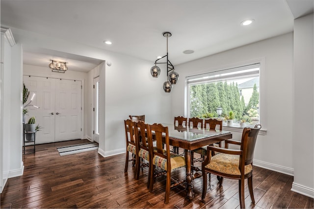 dining area with baseboards, dark wood finished floors, and recessed lighting