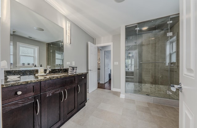 full bathroom with a stall shower, visible vents, baseboards, and vanity