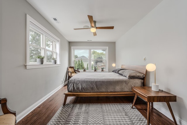 bedroom with visible vents, ceiling fan, baseboards, and wood finished floors