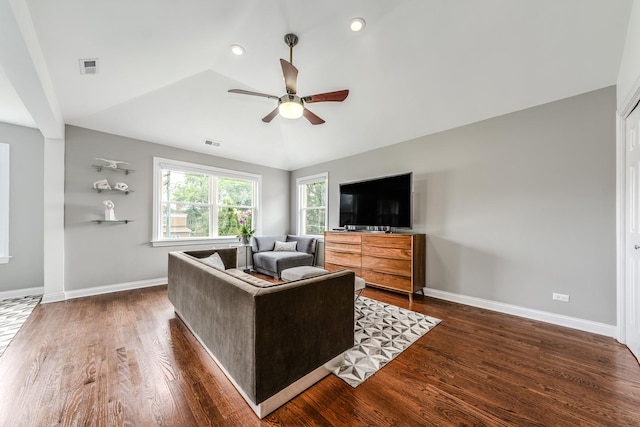 living area featuring lofted ceiling, dark wood-style floors, visible vents, and baseboards