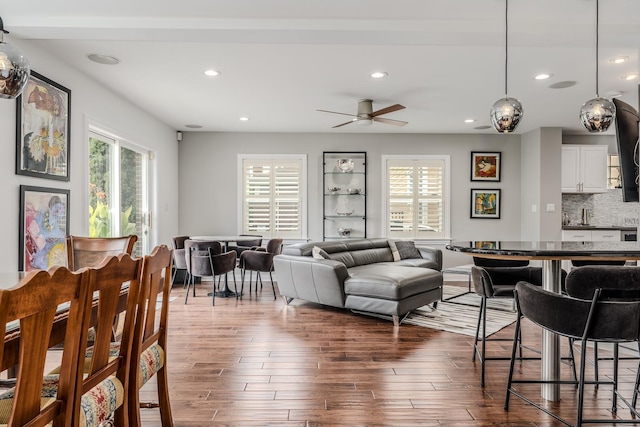 living room with dark wood-style flooring, recessed lighting, a ceiling fan, and a healthy amount of sunlight