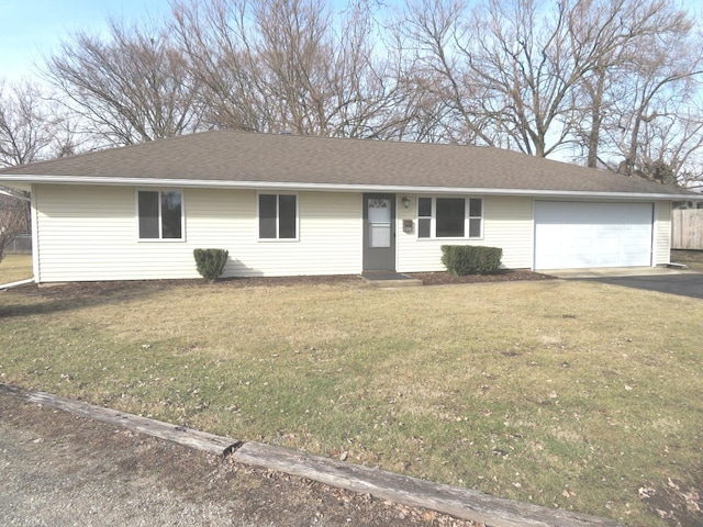 ranch-style house featuring driveway, roof with shingles, a garage, and a front yard