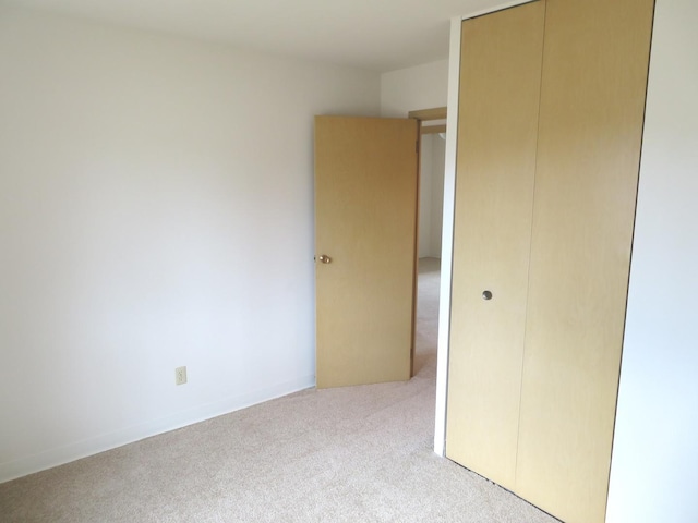 unfurnished bedroom featuring a closet and carpet flooring