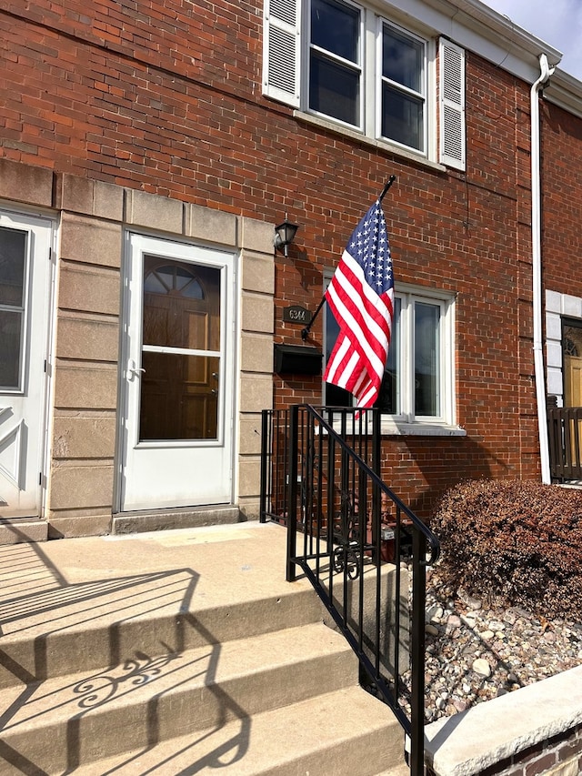 view of exterior entry with brick siding