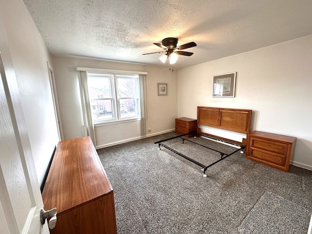 unfurnished bedroom featuring a textured ceiling, baseboards, and carpet flooring