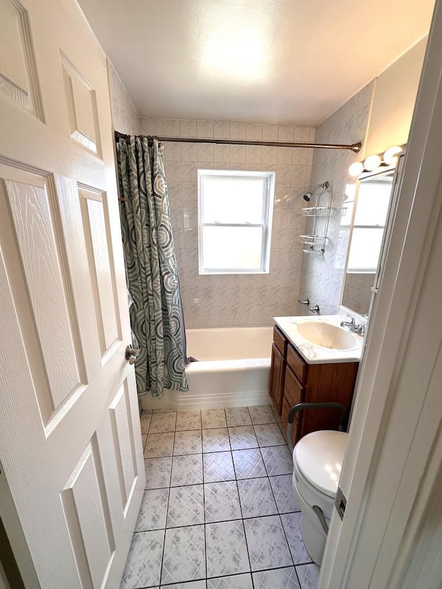 bathroom featuring toilet, tile patterned flooring, vanity, and shower / tub combo with curtain