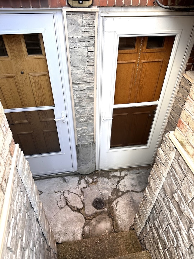 doorway to property featuring stone siding