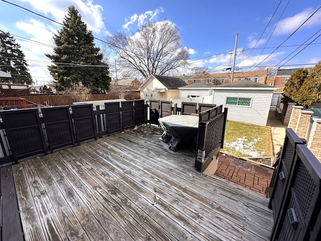 wooden terrace with an outbuilding and fence