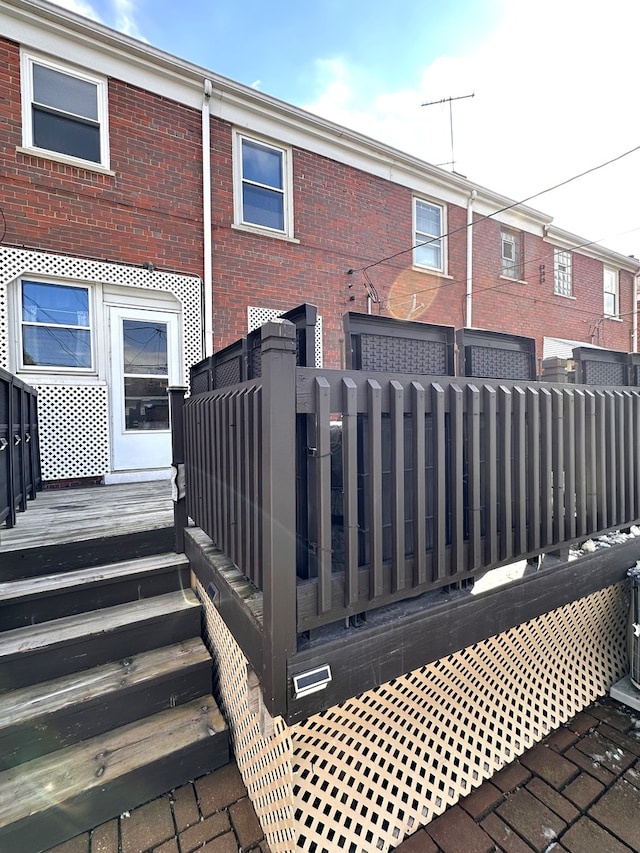 rear view of house featuring brick siding