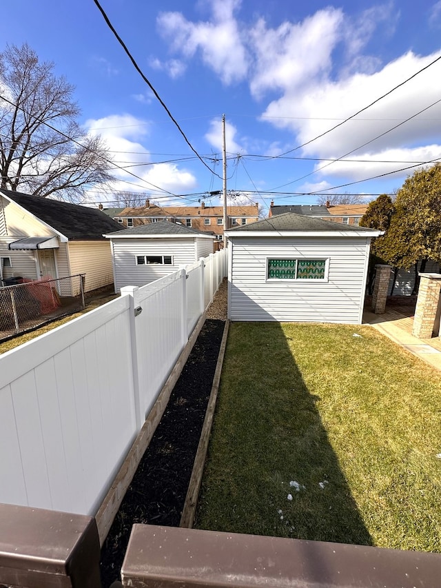 view of yard featuring fence and an outdoor structure