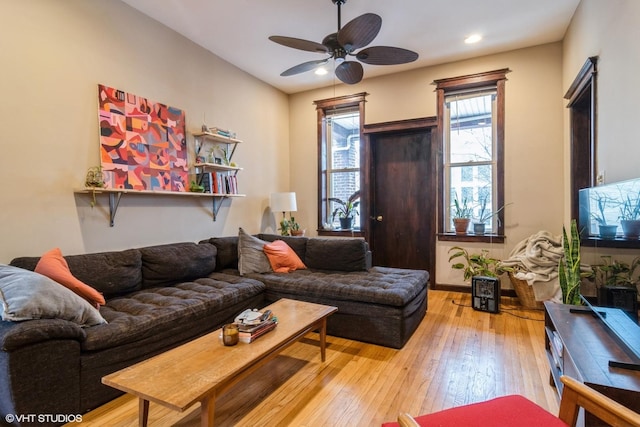 living area with hardwood / wood-style flooring, a ceiling fan, and recessed lighting