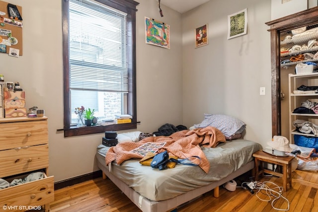 bedroom with wood finished floors and baseboards