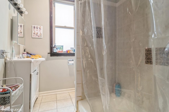 full bathroom featuring baseboards, a stall shower, vanity, and tile patterned floors