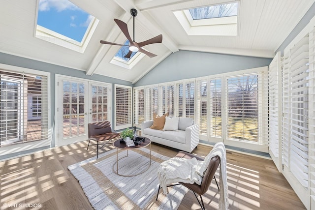 sunroom with vaulted ceiling with skylight and ceiling fan