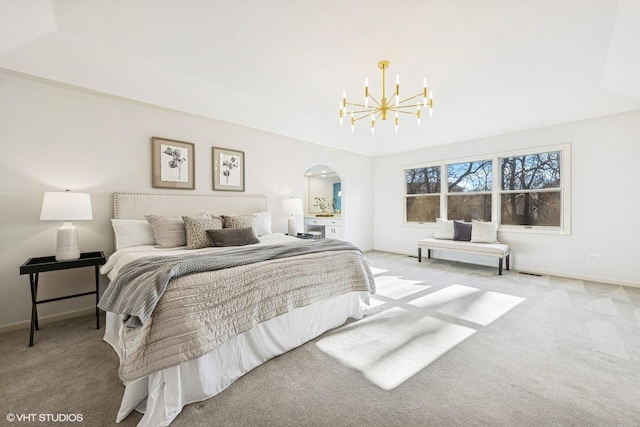 bedroom with arched walkways, carpet flooring, baseboards, and an inviting chandelier