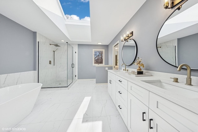 bathroom featuring marble finish floor, a marble finish shower, double vanity, a sink, and a freestanding tub