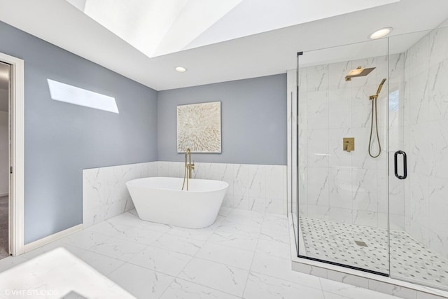 full bathroom with marble finish floor, a freestanding tub, a marble finish shower, and recessed lighting