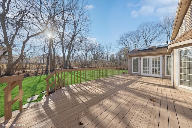 deck with a yard and french doors