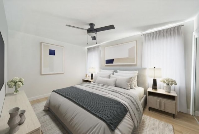 bedroom featuring baseboards, ceiling fan, and light wood-style floors