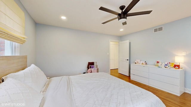 bedroom with a ceiling fan, recessed lighting, visible vents, and wood finished floors