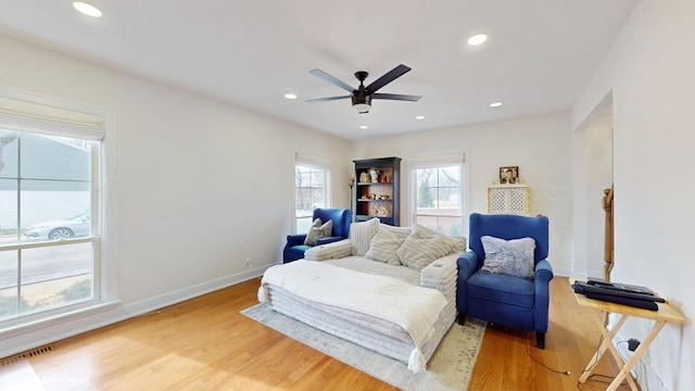 living area featuring recessed lighting, light wood-type flooring, a ceiling fan, and baseboards