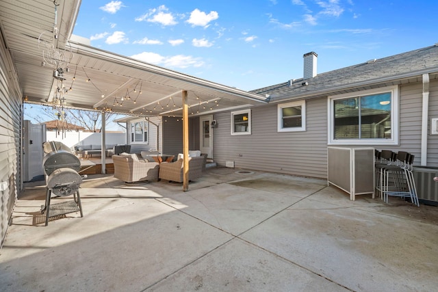 view of patio featuring an attached carport and outdoor lounge area