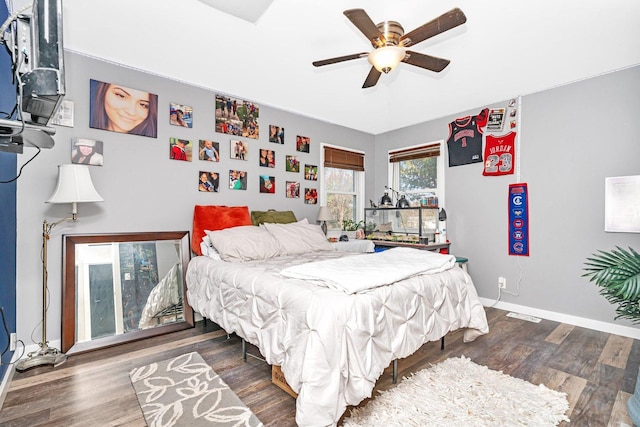 bedroom featuring ceiling fan, wood finished floors, and baseboards