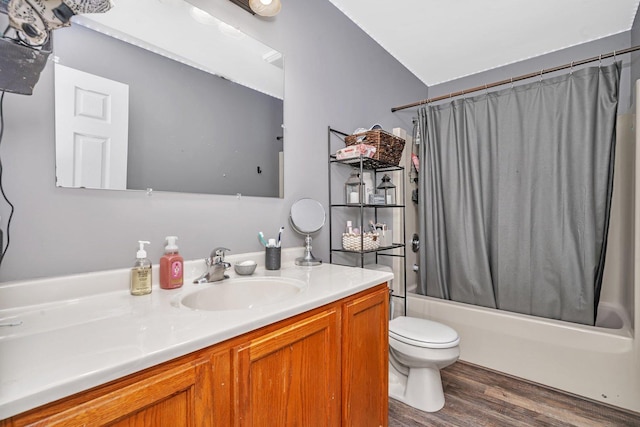 full bath with shower / tub combo with curtain, vanity, toilet, and wood finished floors