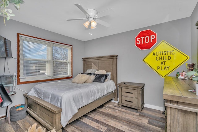 bedroom featuring a ceiling fan, baseboards, and wood finished floors