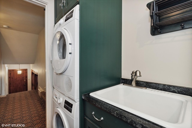 laundry room with laundry area, a sink, and stacked washer / drying machine