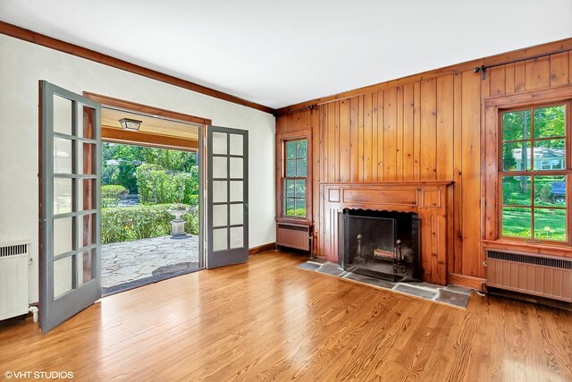 unfurnished living room with radiator and wood finished floors