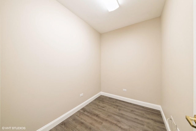 unfurnished room with wood finished floors and baseboards