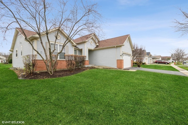 view of side of property featuring concrete driveway, brick siding, a yard, and an attached garage