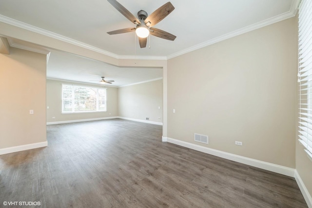 spare room featuring baseboards, visible vents, a ceiling fan, wood finished floors, and crown molding