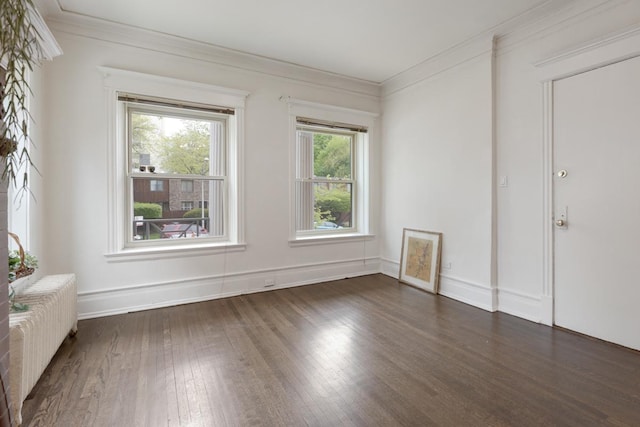 unfurnished room with ornamental molding, radiator, baseboards, and dark wood-style floors