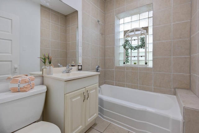 full bathroom featuring toilet, a tub, tile patterned floors, vanity, and tile walls