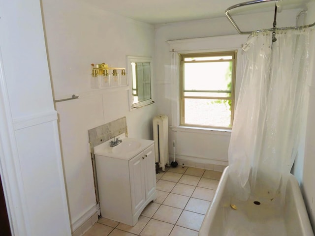 full bath with radiator heating unit, shower / bath combo with shower curtain, vanity, and tile patterned floors