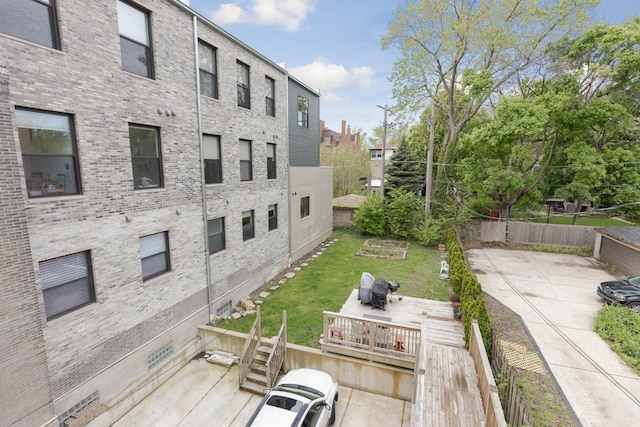 exterior space with fence and a lawn