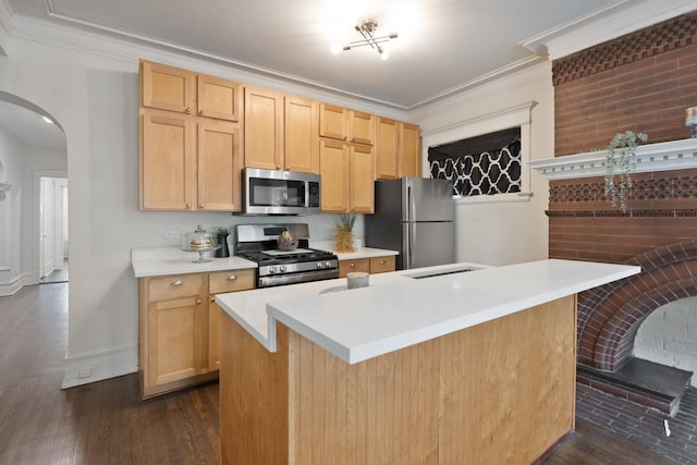 kitchen featuring dark wood-style floors, arched walkways, light countertops, appliances with stainless steel finishes, and ornamental molding