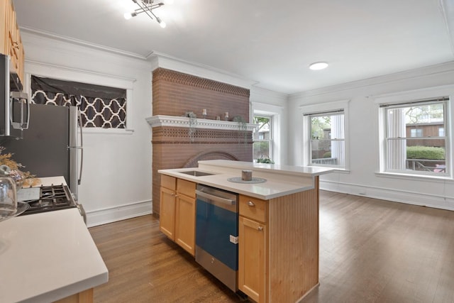 kitchen with a wealth of natural light, light countertops, dishwasher, and wood finished floors