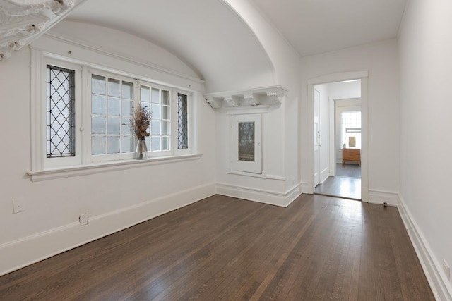 unfurnished room featuring dark wood finished floors and baseboards