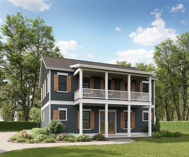 view of front facade with roof with shingles, a porch, board and batten siding, a front yard, and a balcony