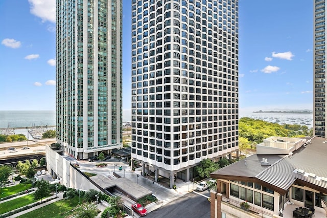 view of property featuring a water view and a view of city