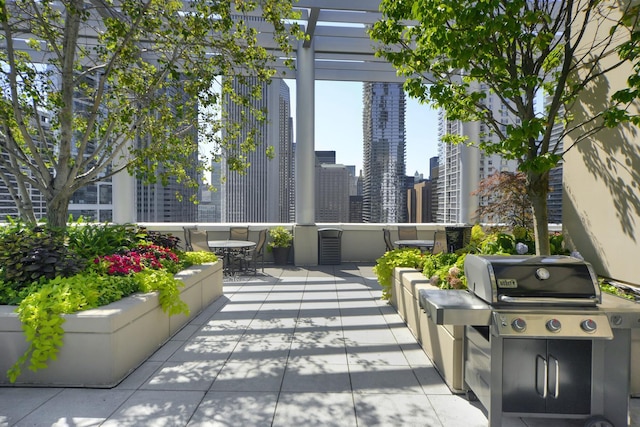 view of patio featuring a city view and a grill