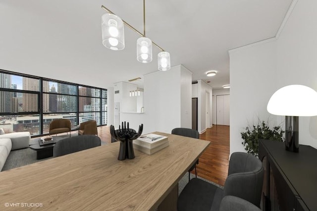 dining area with dark wood-style floors and expansive windows