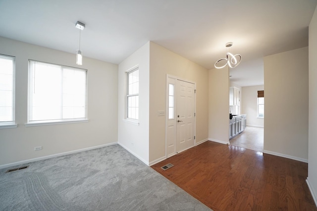 entrance foyer with dark wood finished floors, visible vents, and baseboards