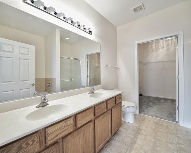 full bath with a stall shower, visible vents, a sink, and double vanity